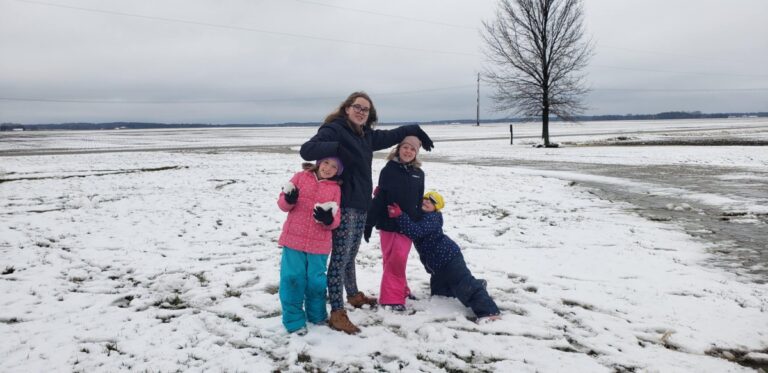 Four kids playing in snow, color photo
