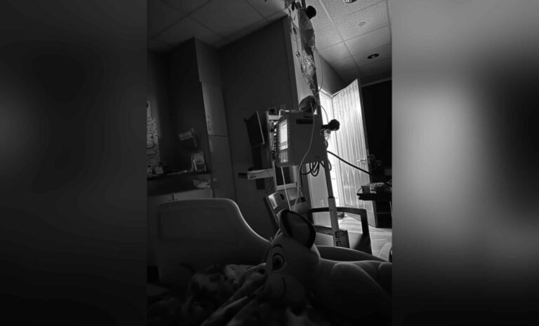 Hospital bed and IV stand, black-and-white photo