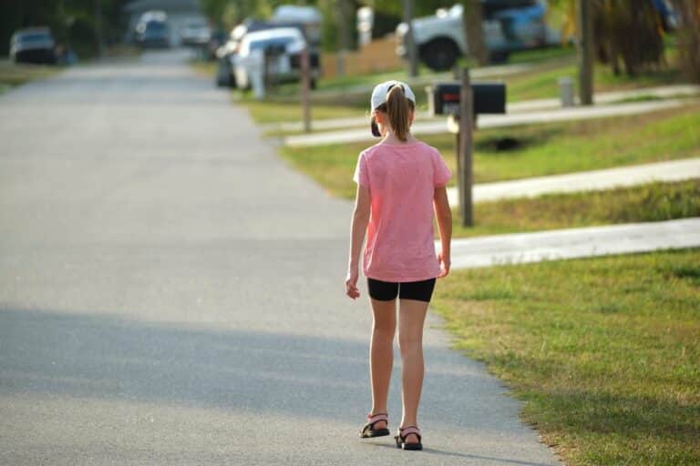 Child walking down street in summertime