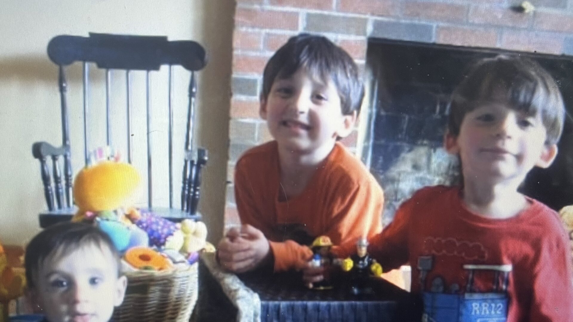 Little boys playing with toys in living room, old photo