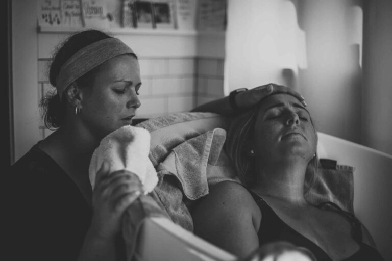 Mother in birthing tub, black-and-white photo