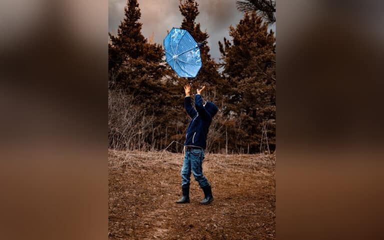 Child playing with umbrella, color photo