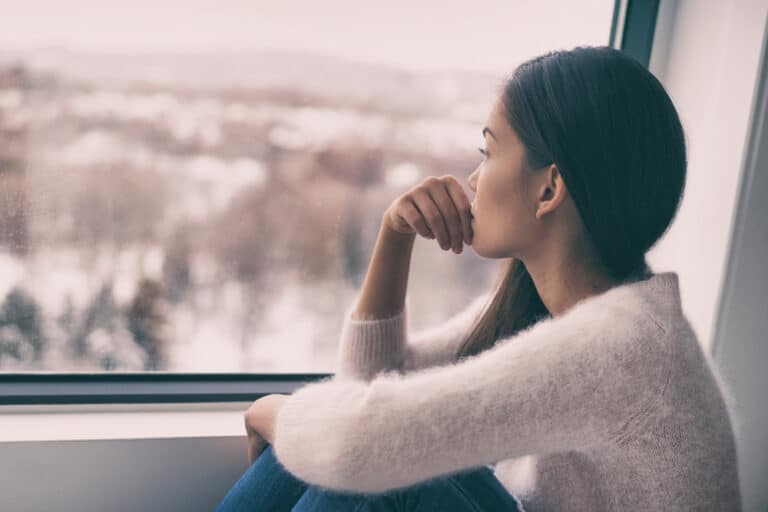 Sad woman looking out window
