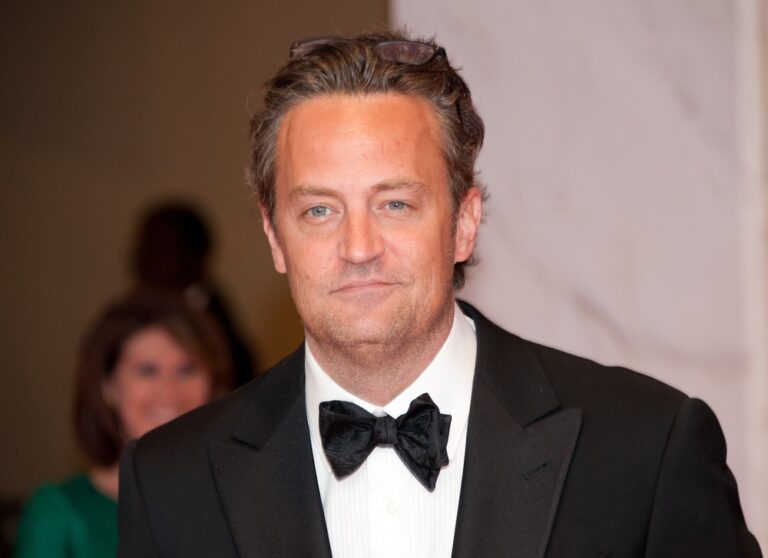 Matthew Perry at a function in black tie and suit