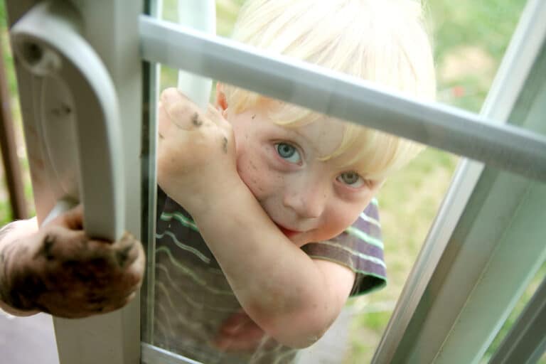Toddler with dirty hands at door