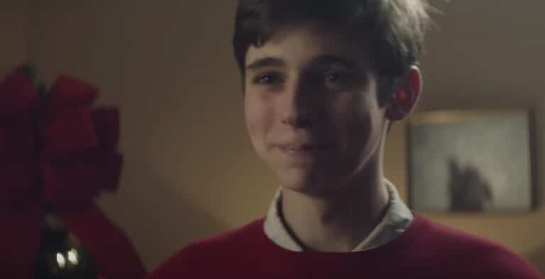 Teen boy smiling in red sweater