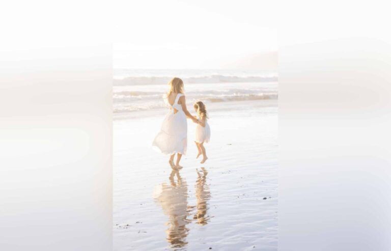 Mother and daughter on beach, color photo