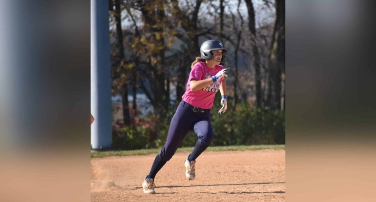 teen girl running bases on softball field, color photo