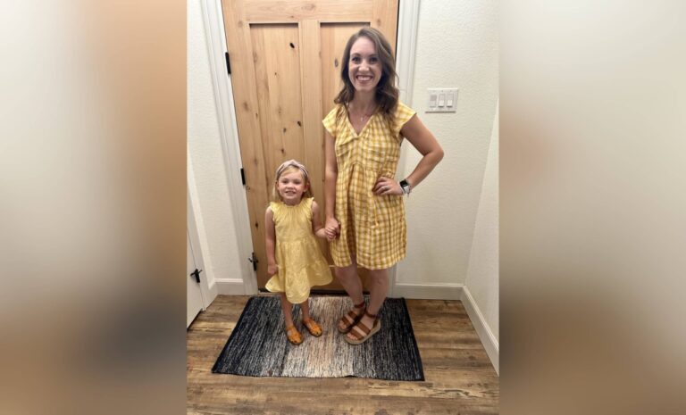 Mother and young daughter wearing yellow dresses, color photo