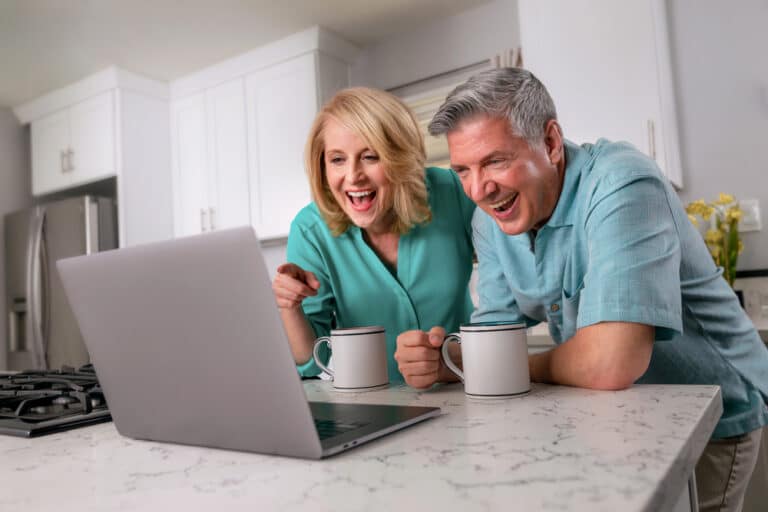 Grandparents looking at computer screen and smiling
