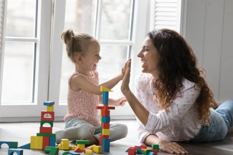 Mother playing blocks with young girl
