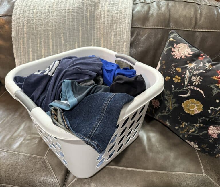 Laundry basket with clothes on couch