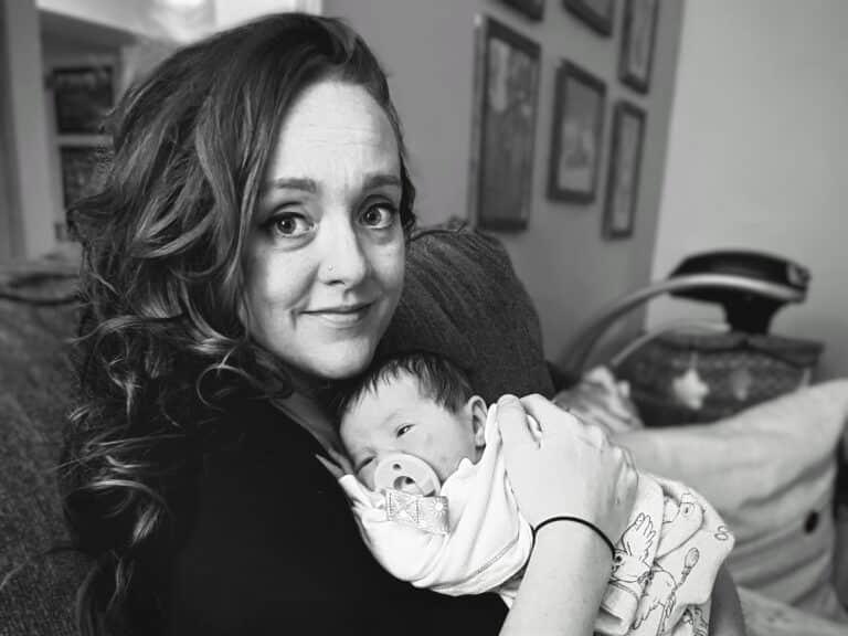 Mother holding newborn baby, black-and-white photo
