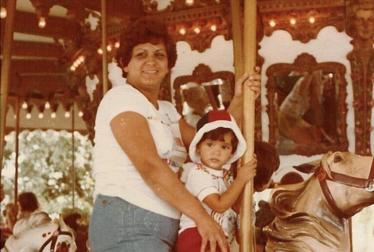 Mother and daughter on a carousel ride, older color photo