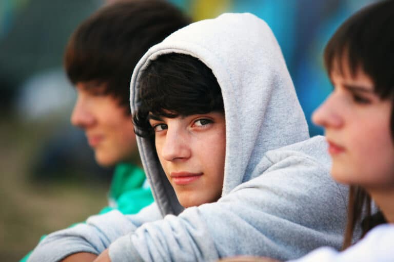 Teen boy smiling wearing a hoodie