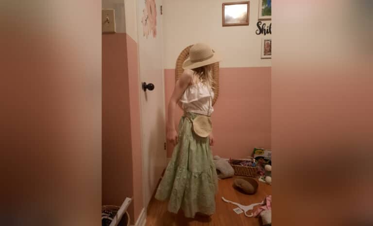 Girl in hat and dress-up clothes, color photo