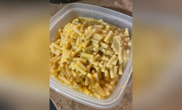 Container with macaroni and cheese, color photo