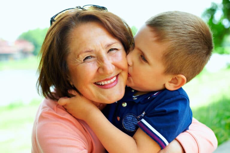 Child kissing grandma on cheek