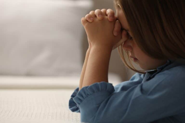 Little girl praying, profile shot