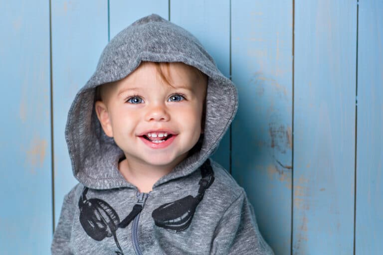 Toddler boy smiling with hoodie on
