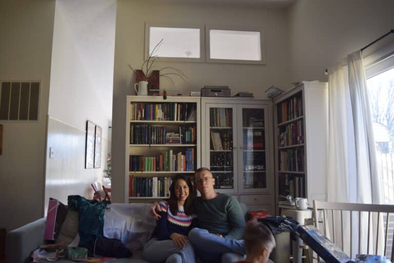 Couple sitting together on couch, color photo