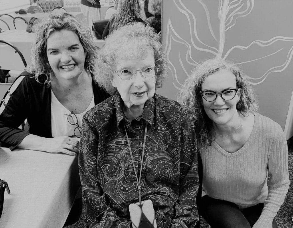 Elderly woman with two grown daughters, black-and-white photo