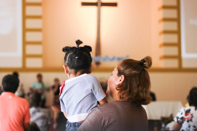 Mother holding young daughter in church