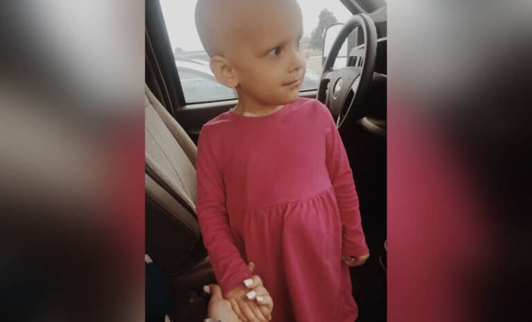 Toddler girl with bald head, color photo