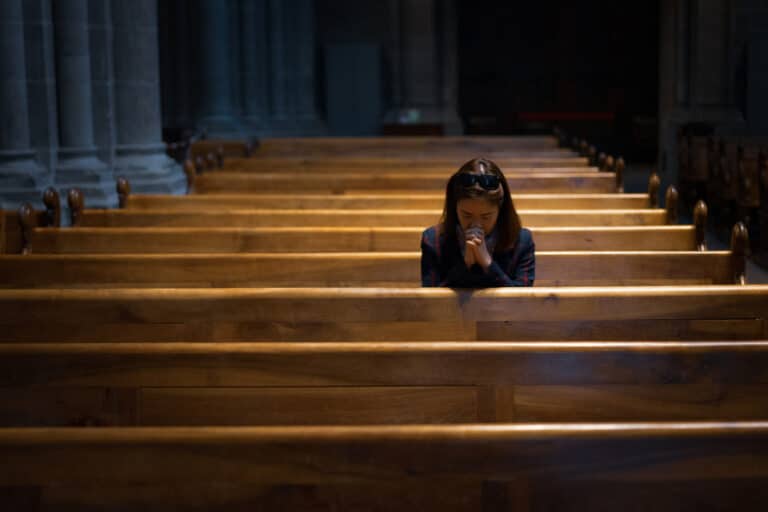 Woman sitting in church pew