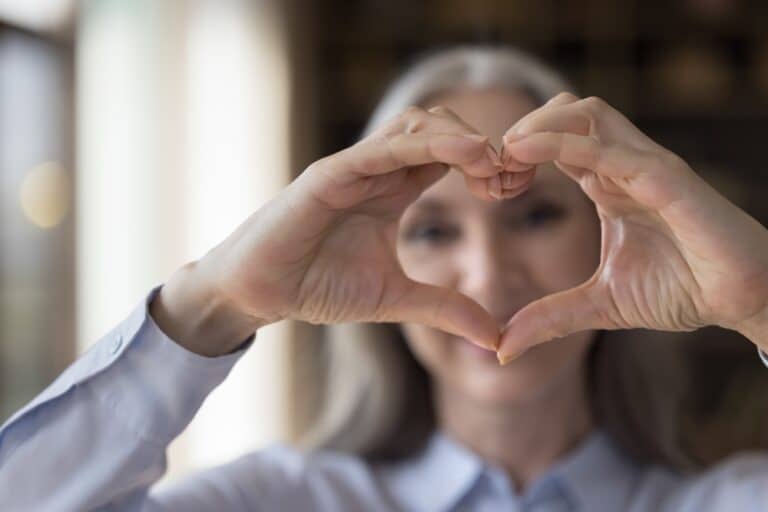 Woman making heart symbol with hands