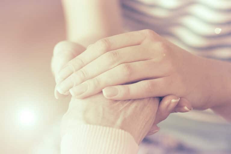 Holding older woman's hand