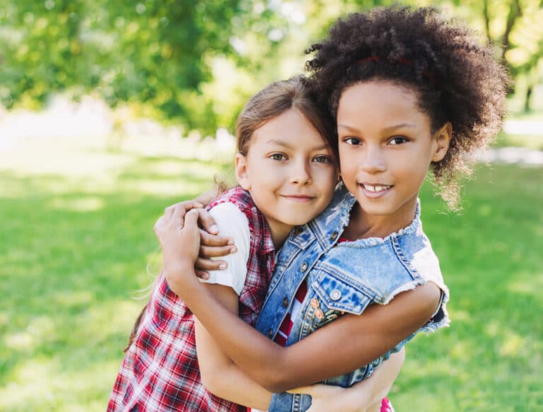 Mixed race girls hugging