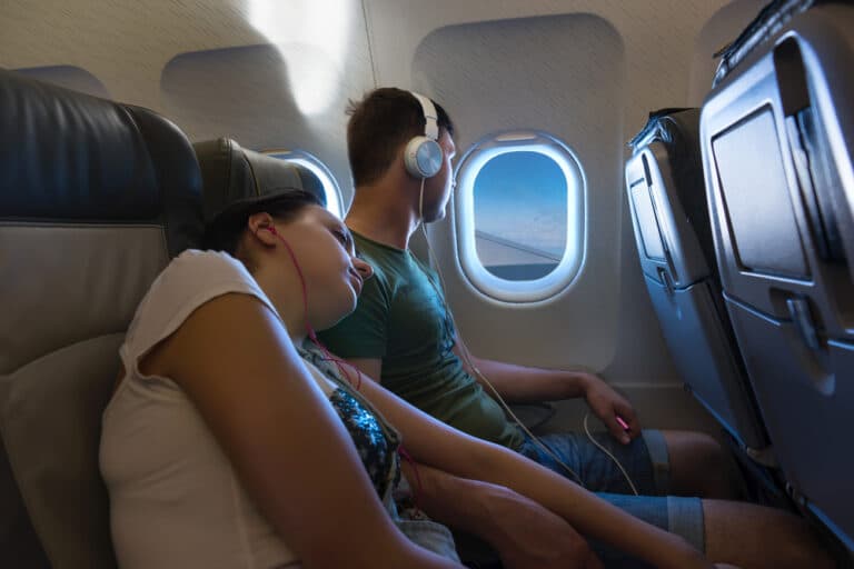 Couple sitting by window in airplane