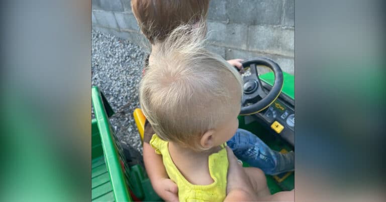 Little boy with arm around little sister, color photo