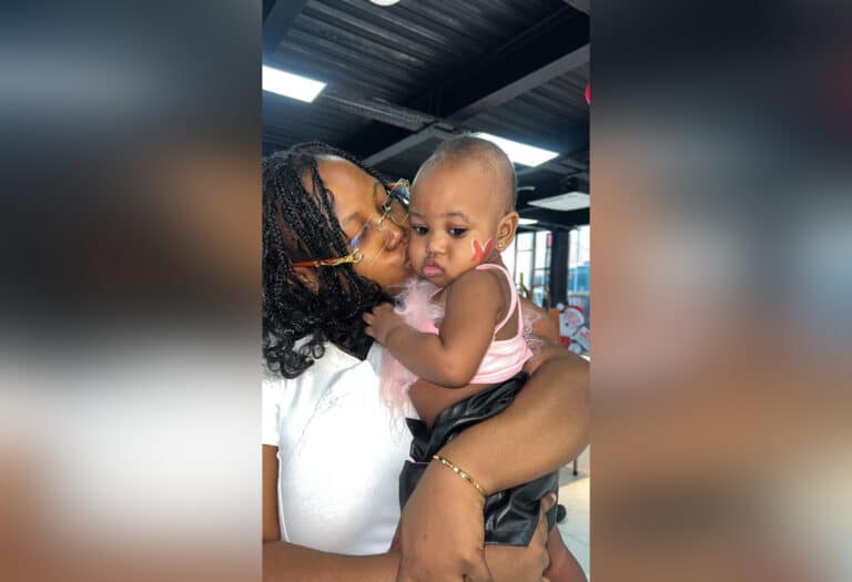 Woman holding baby, color photo