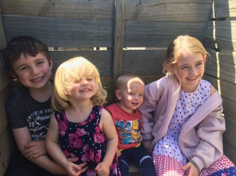 Four kids smiling in posed photo