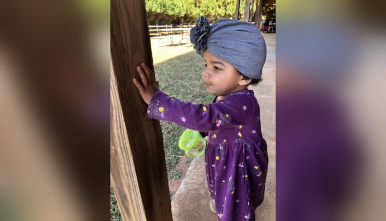 Little girl looking at backyard