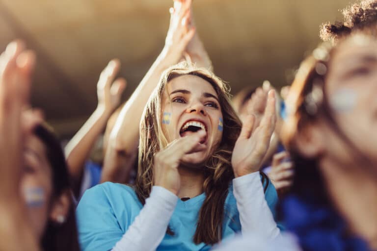 Woman loudly cheering in stands