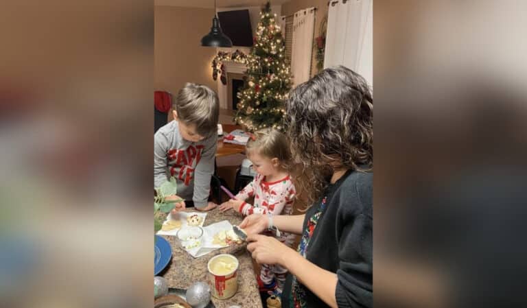Mother with kids decorating cookies at Christmas