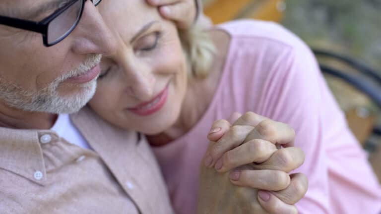 Older couple holding hands
