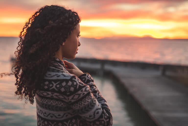 Woman looking toward sunrise