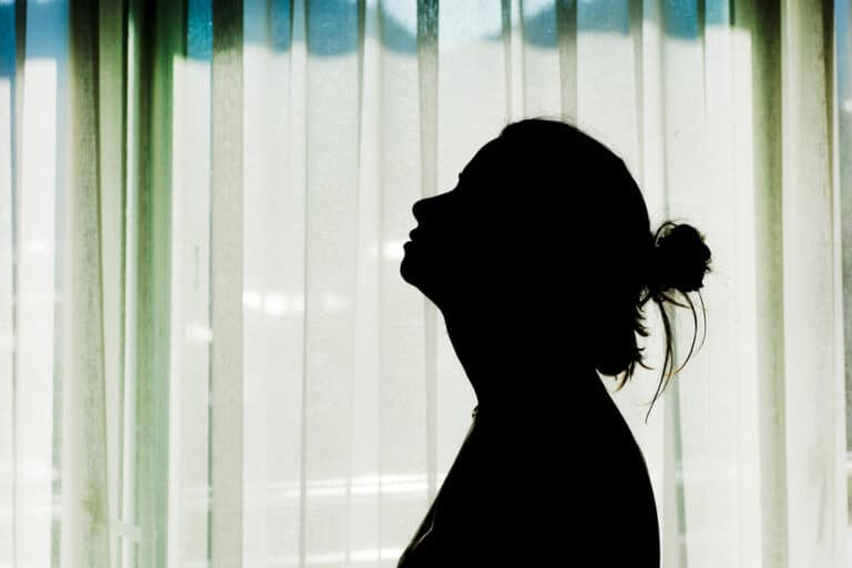 Woman tired with head tilted back, silhouette