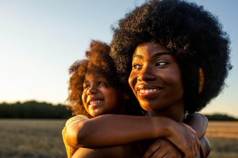 Mother and daughter in sunlight