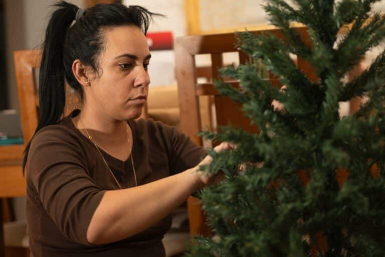 Woman putting up artificial tree