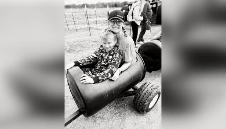 kids riding in tractor in black and white photo