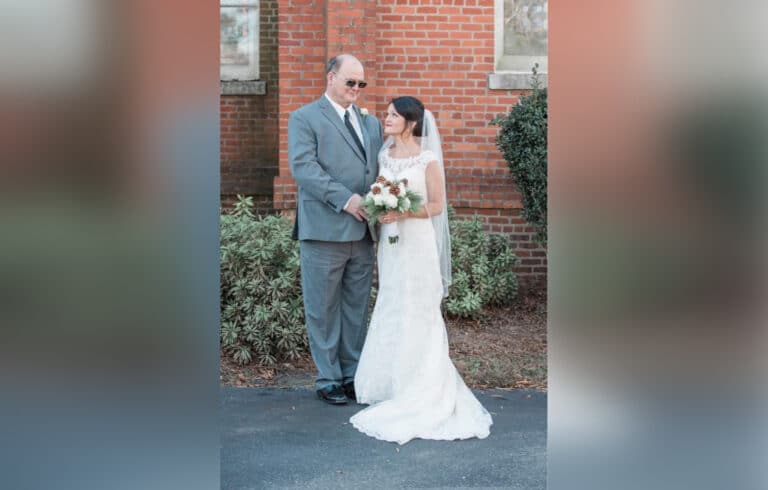 Bride standing with her father
