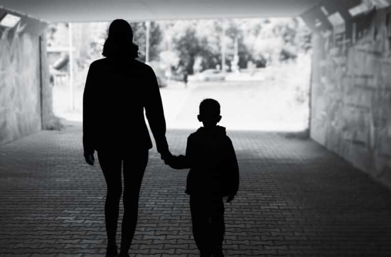 Mother walking with child, silhouette