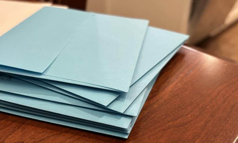 Stack of handwritten letters in blue envelopes