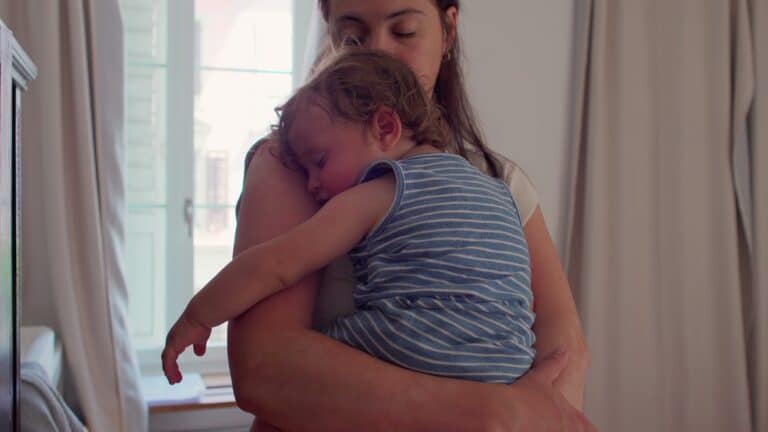 Mother holding sleeping child