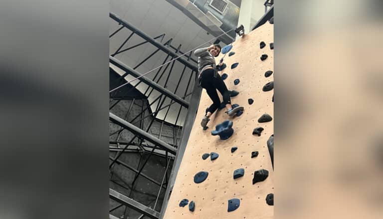 Young woman rock climbing
